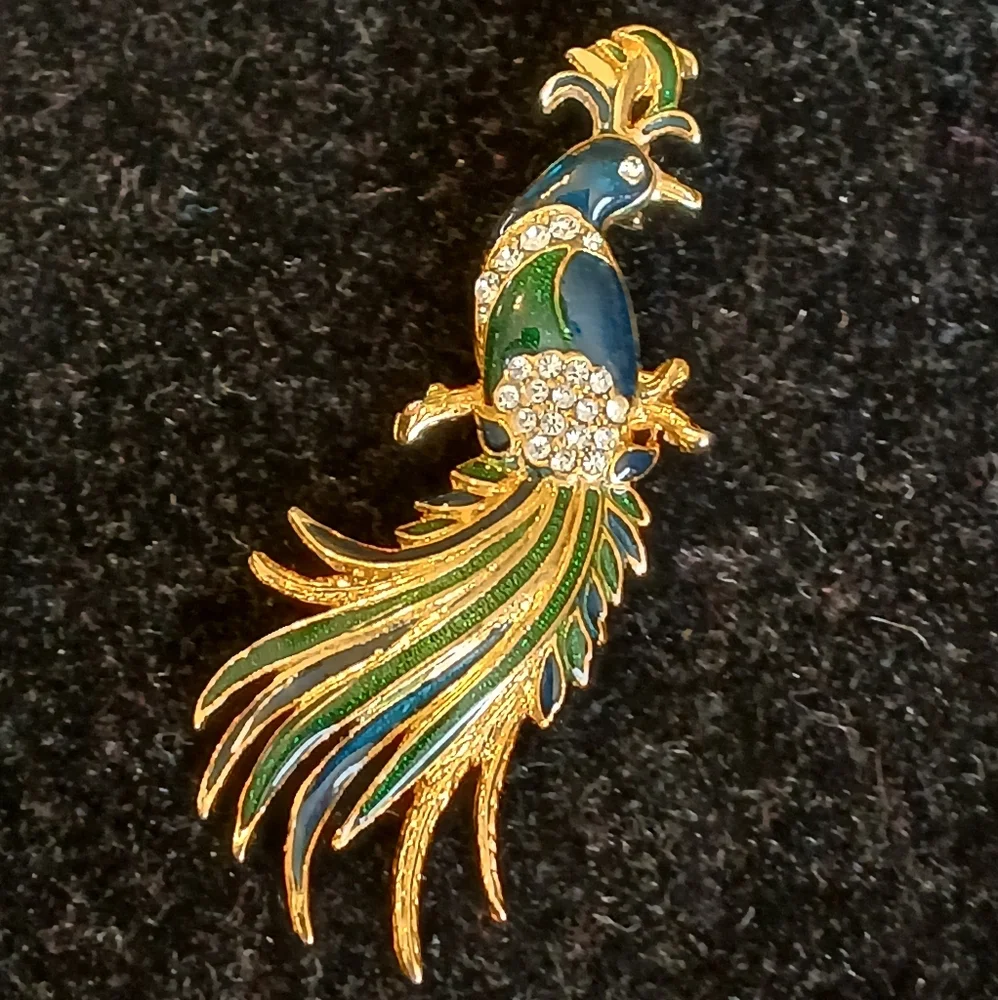 Goldtone peacock brooch with blue and green accents